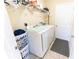 Functional laundry room with modern washer and dryer units and shelving for storage at 6250 Se 88Th St, Ocala, FL 34472