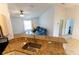 Bright living room with large windows, tile flooring, and seamless connection to the kitchen area at 6250 Se 88Th St, Ocala, FL 34472