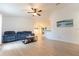 Bright living room boasts vaulted ceilings, light floors, and a ceiling fan for comfortable living at 6250 Se 88Th St, Ocala, FL 34472