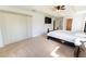 The main bedroom showcases a large window, a ceiling fan and access to the en suite bath at 6250 Se 88Th St, Ocala, FL 34472