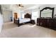 Serene main bedroom with plush carpet, a beautiful wood bed frame, and elegant decor at 6250 Se 88Th St, Ocala, FL 34472