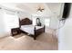 Spacious main bedroom featuring a tray ceiling, carpeted floors and ample natural light at 6250 Se 88Th St, Ocala, FL 34472