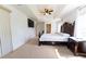 Spacious main bedroom featuring tray ceilings, a ceiling fan, and natural light from two windows at 6250 Se 88Th St, Ocala, FL 34472