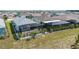 Aerial view of home featuring screened patios, well-maintained lawn, and landscaping in a residential neighborhood at 8905 Sw 76Th Ln, Ocala, FL 34481