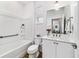 Clean bathroom featuring tub-shower combo, white vanity and wood-look floors at 8905 Sw 76Th Ln, Ocala, FL 34481