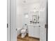Cozy bathroom features a tub-shower combo, wood-look floors and a modern vanity with storage at 8905 Sw 76Th Ln, Ocala, FL 34481
