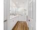 Modern bathroom boasts double sinks, a glass-enclosed shower, and wood-look flooring at 8905 Sw 76Th Ln, Ocala, FL 34481
