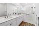 Modern bathroom boasts double sinks, a glass-enclosed shower, and wood-look flooring at 8905 Sw 76Th Ln, Ocala, FL 34481
