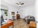 Bedroom with a ceiling fan, closet, natural light and wood-look floors perfect for a home office at 8905 Sw 76Th Ln, Ocala, FL 34481