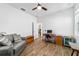Bedroom with wood-look floors, ceiling fan, desk and comfortable sitting area at 8905 Sw 76Th Ln, Ocala, FL 34481