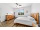 Bright bedroom features wood-look floors, ceiling fan, and a large window for natural light at 8905 Sw 76Th Ln, Ocala, FL 34481