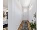 Hallway featuring wood-look floors, white walls, and white doors to other rooms in the home at 8905 Sw 76Th Ln, Ocala, FL 34481