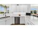 Bright kitchen featuring stainless steel dishwasher, white cabinets, and eat-in countertops at 8905 Sw 76Th Ln, Ocala, FL 34481