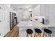 Modern kitchen with stainless steel appliances, white cabinets, bar seating, and gorgeous countertops at 8905 Sw 76Th Ln, Ocala, FL 34481