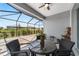 Comfortable screened lanai with a dining set, offering views of the landscaped backyard and providing a relaxed outdoor setting at 8905 Sw 76Th Ln, Ocala, FL 34481