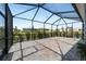 Expansive screened lanai with brick pavers, providing a large outdoor area with views of the landscaped backyard and neighborhood at 8905 Sw 76Th Ln, Ocala, FL 34481