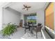 Cozy screened lanai with a ceiling fan, furnished with a round table set, and featuring a peaceful backyard view at 8905 Sw 76Th Ln, Ocala, FL 34481