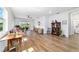 Bright living room with wood-look floors and white walls that boasts a ceiling fan and sliding glass doors at 8905 Sw 76Th Ln, Ocala, FL 34481