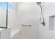 This tiled shower features a built-in bench, handheld sprayer and convenient recessed shelving at 8905 Sw 76Th Ln, Ocala, FL 34481