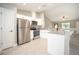 Modern kitchen featuring stainless steel appliances, granite countertops, white cabinets, and an open layout at 8937 Se Highway 42, Summerfield, FL 34491
