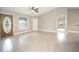 Spacious open-concept living room featuring tile flooring, high ceilings, and ample natural light from large windows at 8937 Se Highway 42, Summerfield, FL 34491