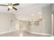 Bright, open-concept living area with tile floors, ceiling fan, and a breakfast bar overlooking additional living spaces at 8937 Se Highway 42, Summerfield, FL 34491