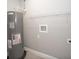 Utility room featuring a modern water heater, plumbing, and shelving, suitable for laundry hookups at 8937 Se Highway 42, Summerfield, FL 34491