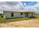 Backyard with a sliding glass door and an open patio area, perfect for outdoor relaxation at 9 Hemlock Terrace Ln, Ocala, FL 34472