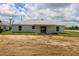 A well-lit backyard with a sliding glass door and a spacious dirt area at 9 Hemlock Terrace Ln, Ocala, FL 34472