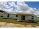 House with a patio and sliding glass doors overlooking a spacious backyard at 9 Hemlock Terrace Ln, Ocala, FL 34472