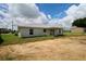 Backyard with an open patio and grassy areas, located on a sunny day at 9 Hemlock Terrace Ln, Ocala, FL 34472
