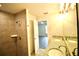 Bathroom features granite countertop double sinks, walk-in shower, and doorway to a bedroom at 9 Hemlock Terrace Ln, Ocala, FL 34472
