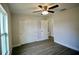 Bedroom with a ceiling fan, gray flooring, a closet, and a window at 9 Hemlock Terrace Ln, Ocala, FL 34472