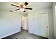 Bright bedroom featuring wood-look floors, a ceiling fan, and a closet with sliding doors at 9 Hemlock Terrace Ln, Ocala, FL 34472
