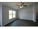 Comfortable bedroom featuring an overhead ceiling fan, a large window, and sleek wood floors at 9 Hemlock Terrace Ln, Ocala, FL 34472