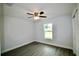 This bedroom includes a ceiling fan, gray flooring, and white walls at 9 Hemlock Terrace Ln, Ocala, FL 34472