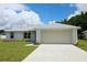 Charming single-story home with a well-manicured lawn and attached two car garage at 9 Hemlock Terrace Ln, Ocala, FL 34472