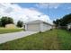 A cozy home featuring an attached two-car garage, clean stucco exterior, and a manicured lawn at 9 Hemlock Terrace Ln, Ocala, FL 34472