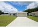 Charming single-story home with a well-manicured lawn and attached two car garage at 9 Hemlock Terrace Ln, Ocala, FL 34472