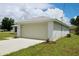 A cozy home featuring an attached two-car garage, clean stucco exterior, and a manicured lawn at 9 Hemlock Terrace Ln, Ocala, FL 34472