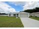 Charming single-story home with a well-manicured lawn and attached two car garage at 9 Hemlock Terrace Ln, Ocala, FL 34472
