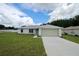 Charming single-story home with a well-manicured lawn and attached two car garage at 9 Hemlock Terrace Ln, Ocala, FL 34472