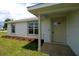 Picture of the home's entrance including freshly landscaped yard and a storm door at 9 Hemlock Terrace Ln, Ocala, FL 34472