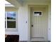 Inviting front entryway with a decorative glass window, well-maintained landscaping, and secure lockbox at 9 Hemlock Terrace Ln, Ocala, FL 34472