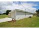 A well-maintained two-car garage with a paved driveway and manicured landscaping at 9 Hemlock Terrace Ln, Ocala, FL 34472
