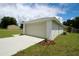 A well-maintained two-car garage with a concrete driveway and tidy landscaping at 9 Hemlock Terrace Ln, Ocala, FL 34472
