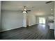 Spacious living room featuring a ceiling fan, modern flooring, and sliding glass doors at 9 Hemlock Terrace Ln, Ocala, FL 34472