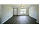 Bright living room features contemporary flooring, a ceiling fan, and a large window at 9 Hemlock Terrace Ln, Ocala, FL 34472
