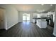 Well-lit living space seamlessly blends with a modern kitchen, and features sleek flooring at 9 Hemlock Terrace Ln, Ocala, FL 34472