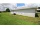 Side yard with green grass and an air conditioning unit on a sunny day at 9 Hemlock Terrace Ln, Ocala, FL 34472